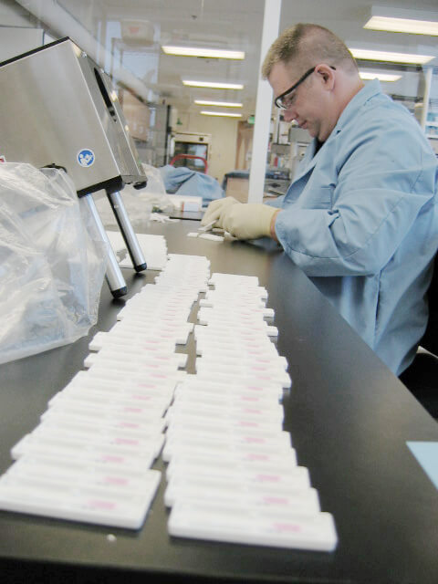 A scientist assembles a point-of-care diagnostic test. Photo: PATH/Dan Chang
